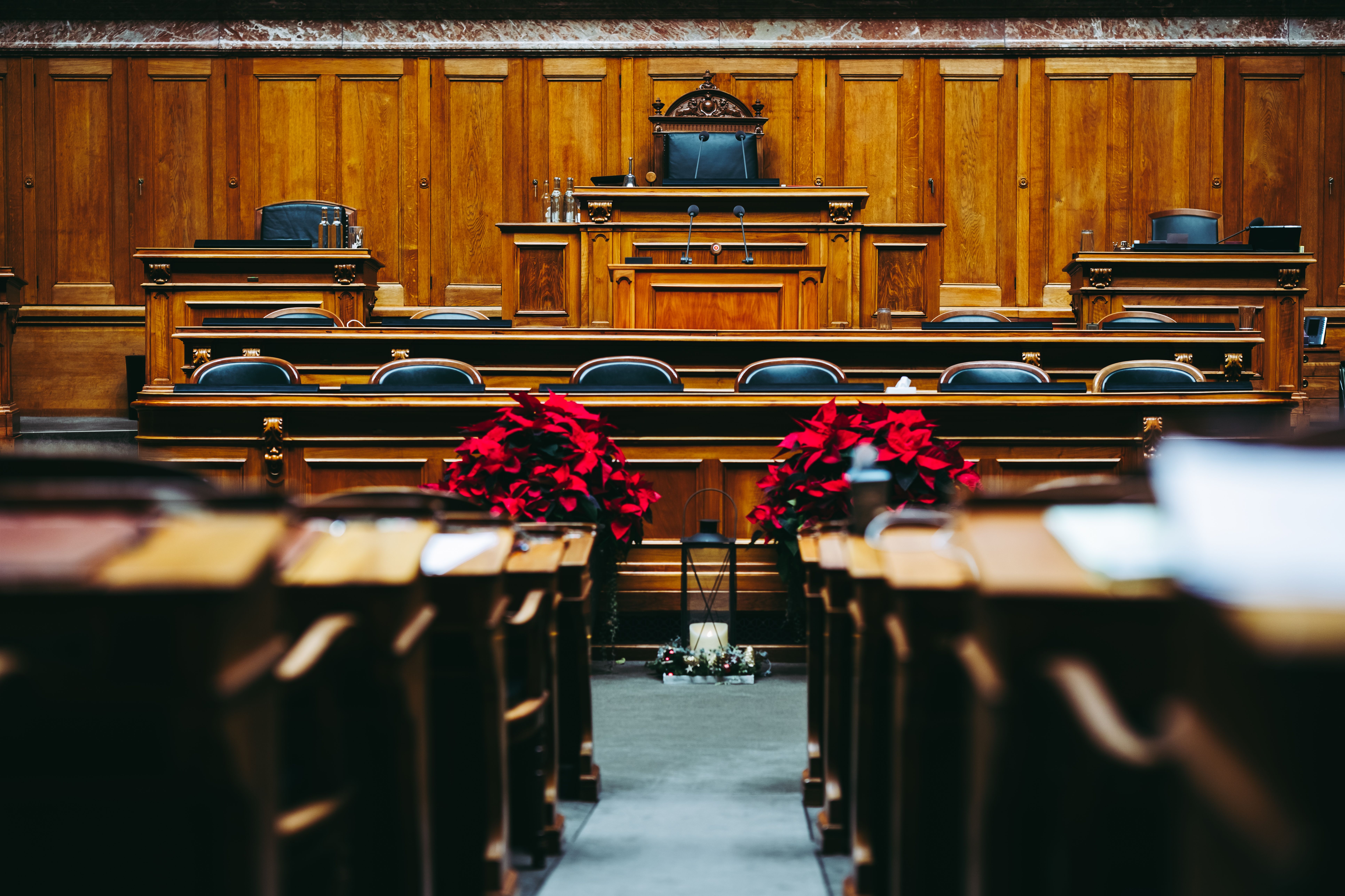 Spacious wooden courtroom with empty seats, illustrating a legal proceeding