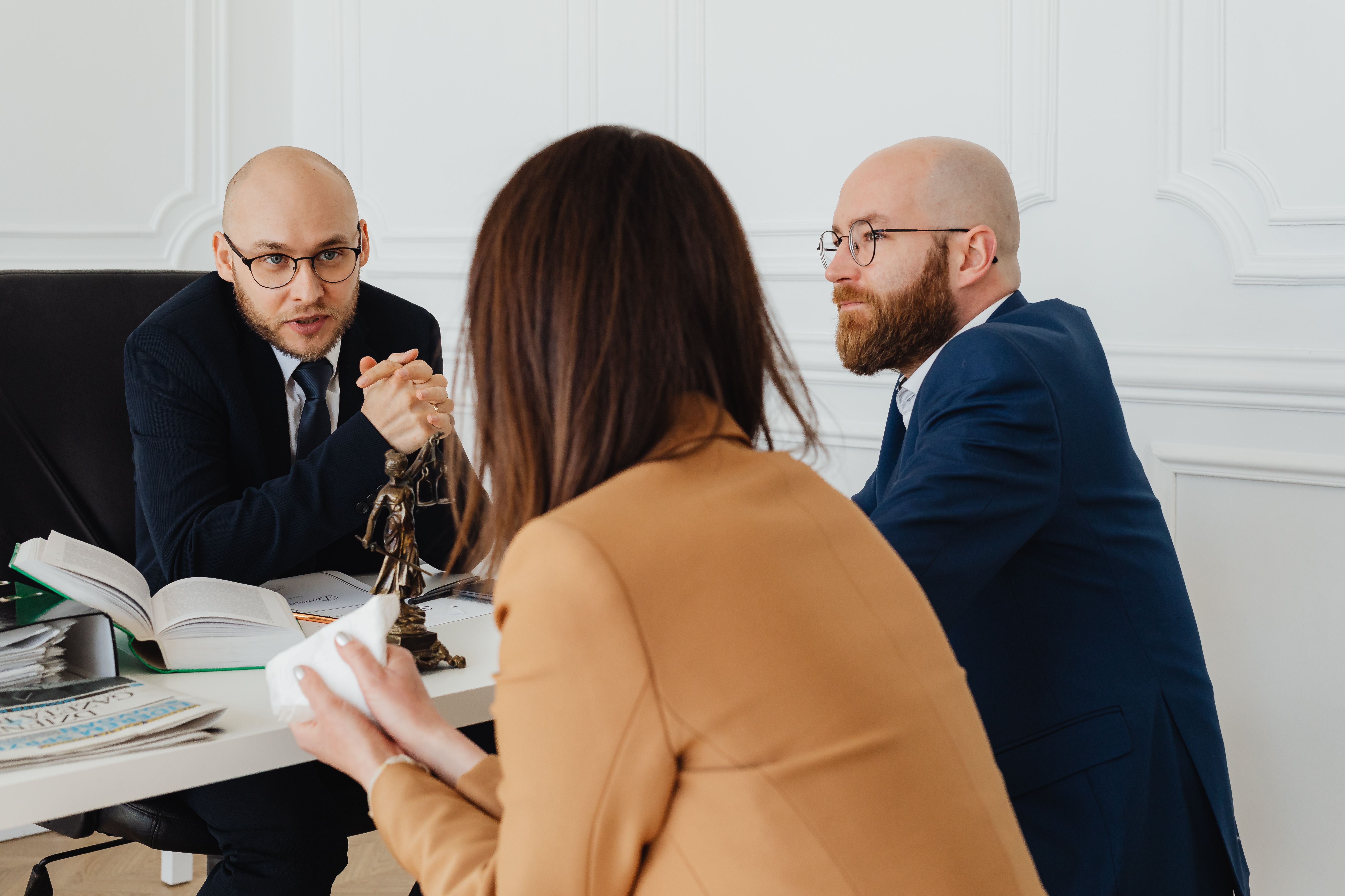 Solicitors and barristers discussing a group litigation claim in a modern UK office