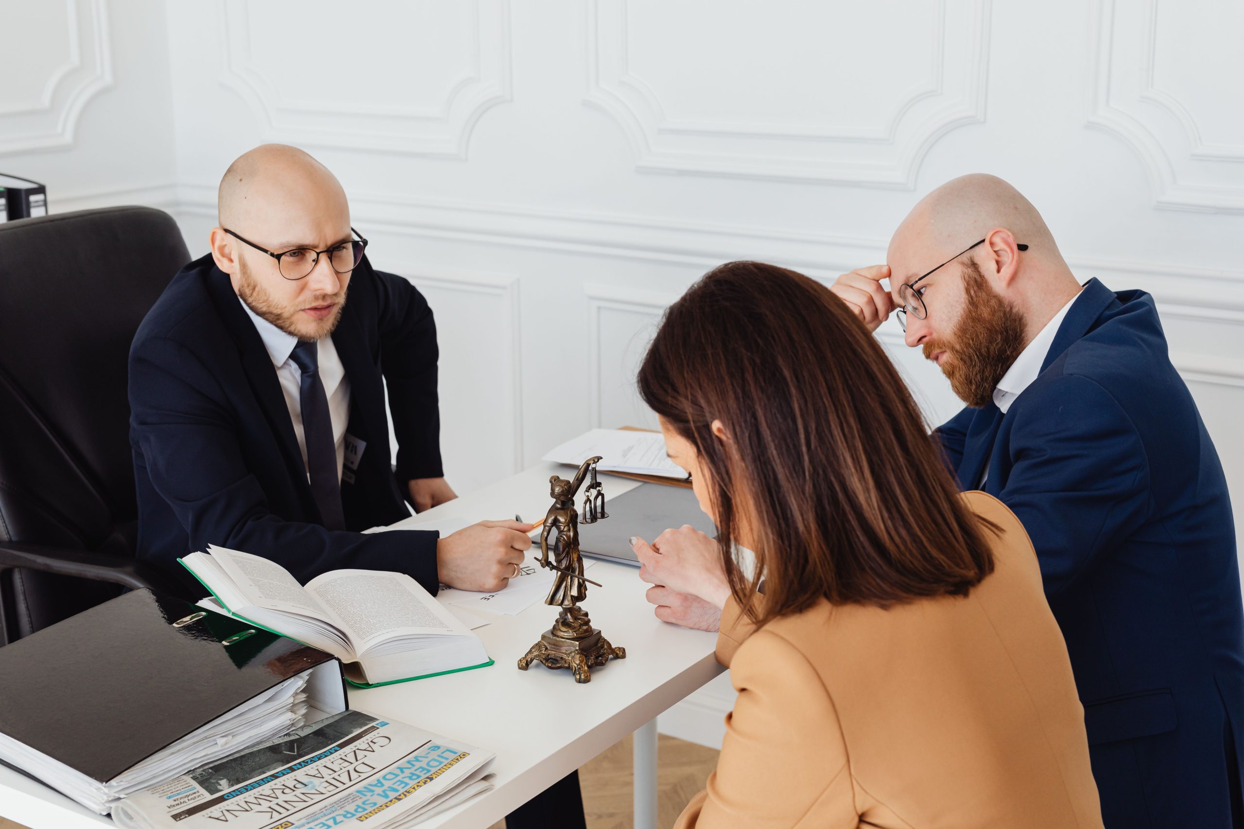 Lawyer consulting clients in a modern office during a serious legal discussion