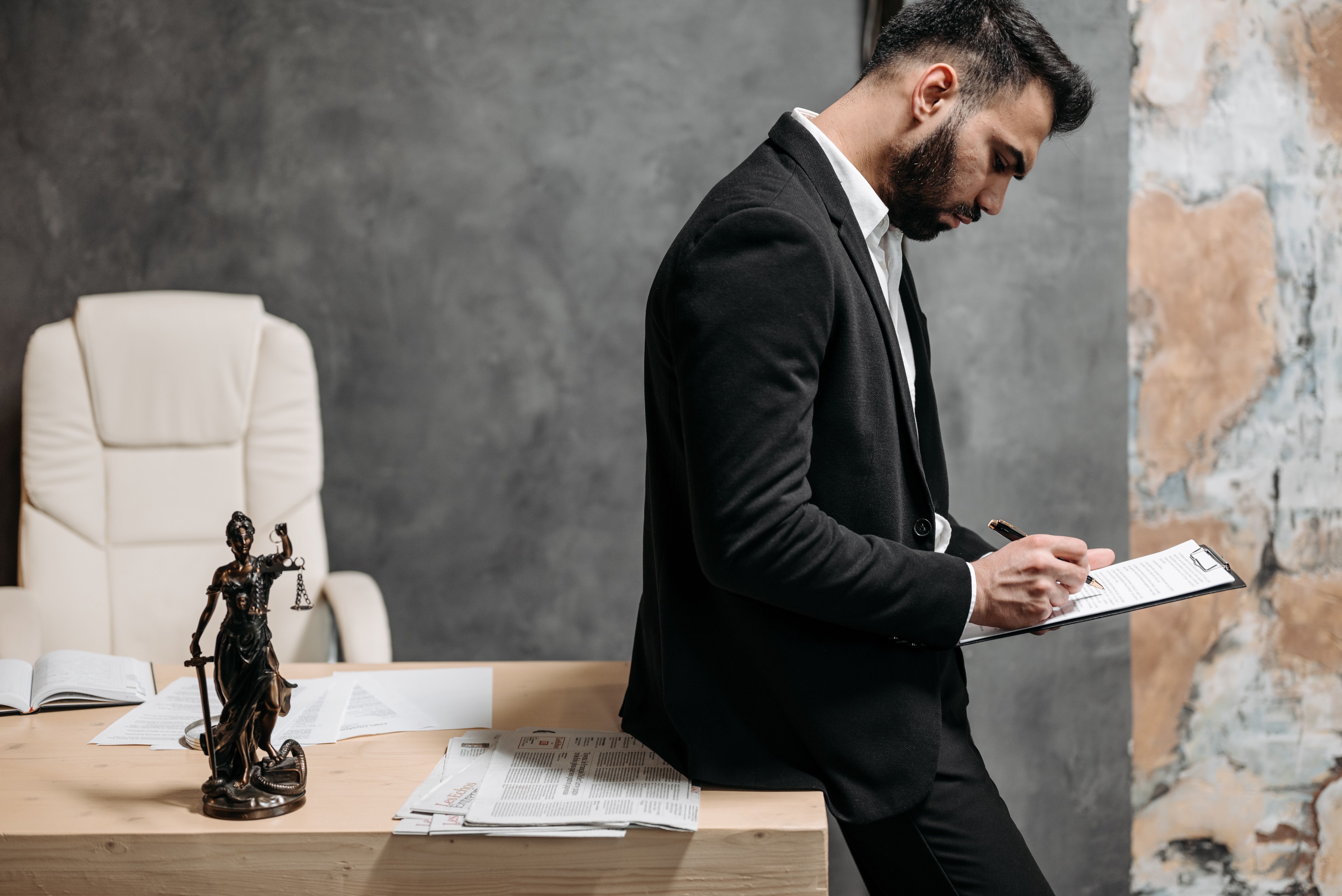Lawyer reviewing case paperwork at an office desk
