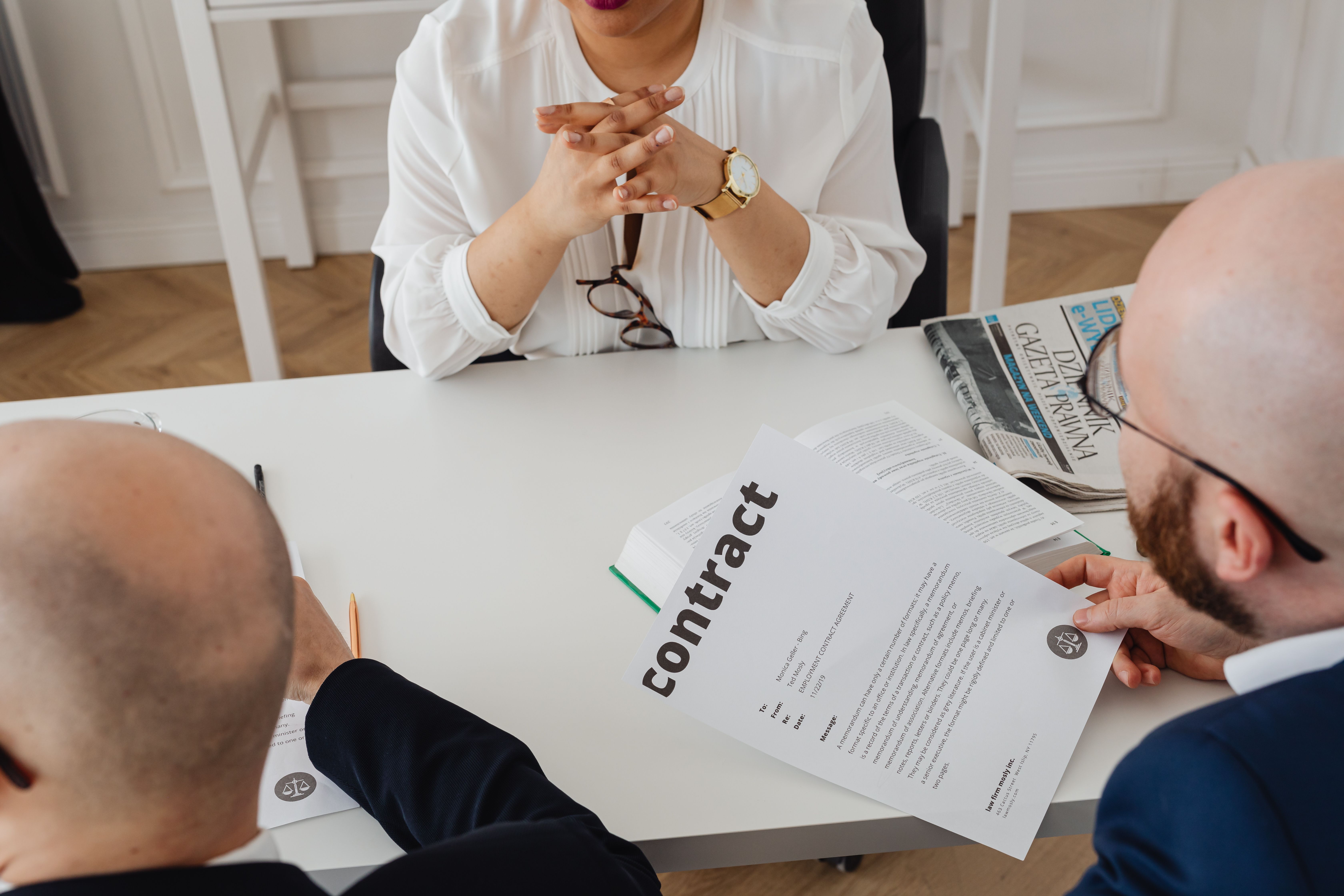 Business professionals discussing a contract in a modern office setting